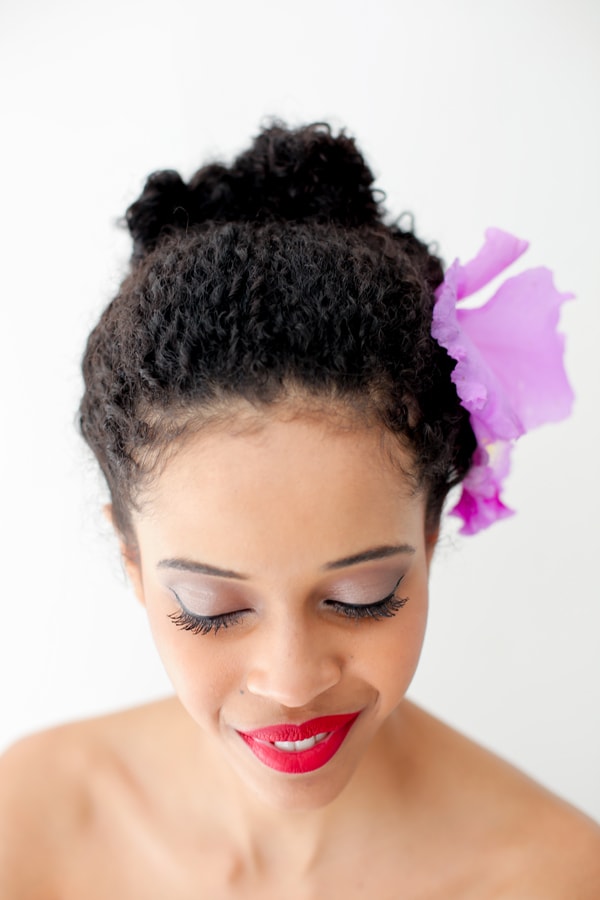 bun hairstyle for curly hair with natural flowers