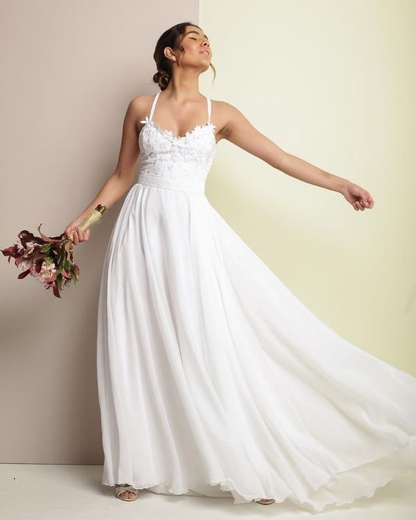 wedding dress with flowing skirt and thin straps for daytime wedding