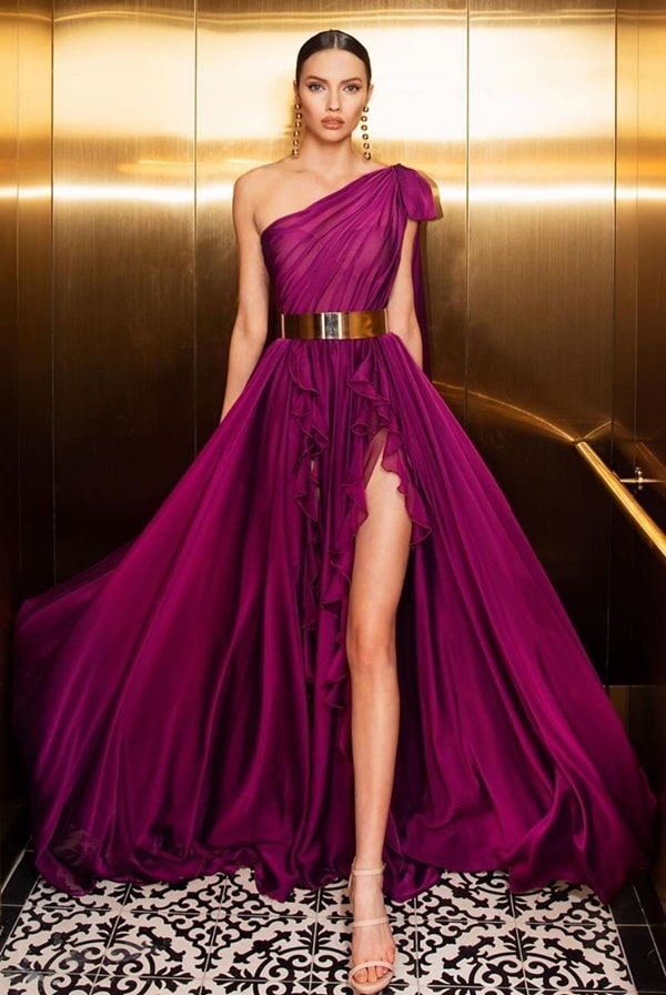 long flowing fuchsia party dress with one shoulder and slit