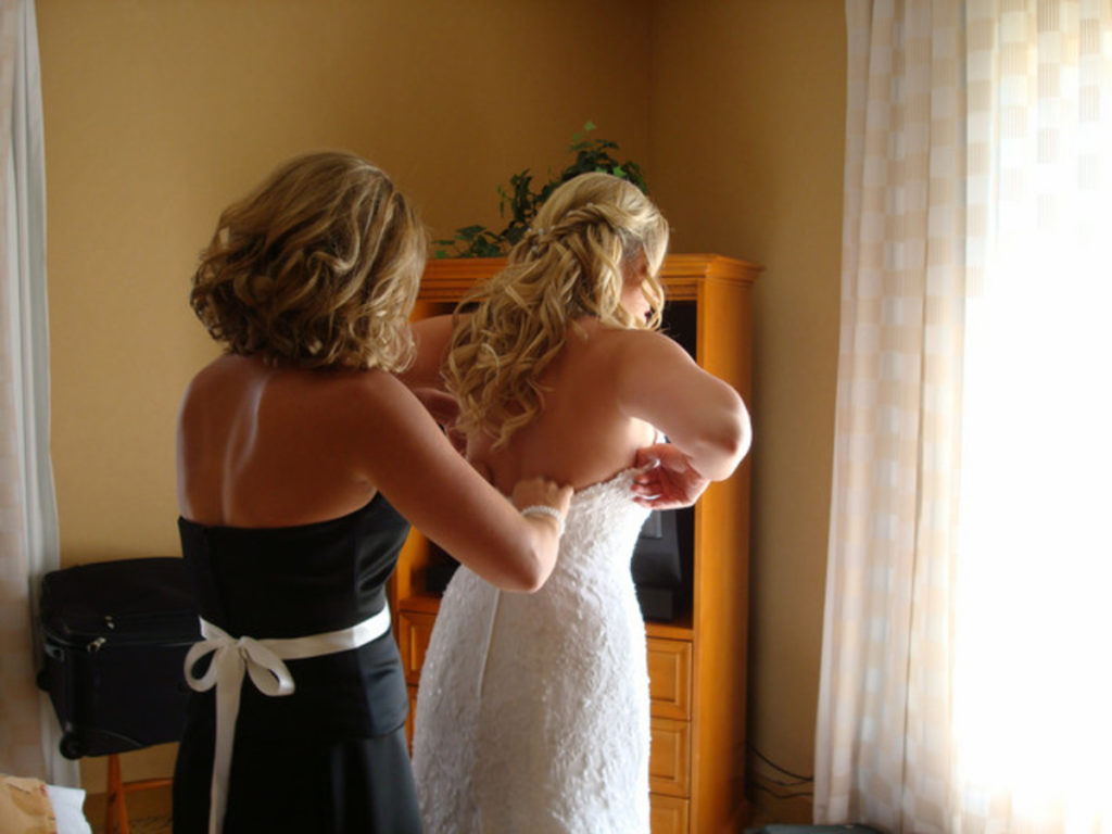 Who helps the bride get dressed?